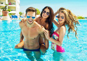 Young People Wear Sunglasses And Having Fun In Swimming Pool