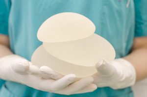 Surgeon Hands Holding Breast Implants